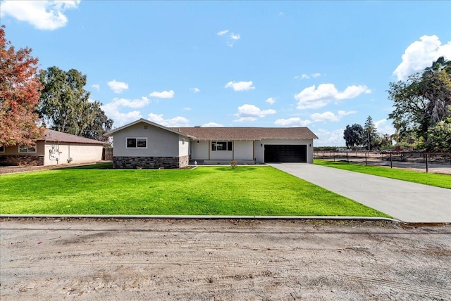 ranch-style house with a garage and a front lawn