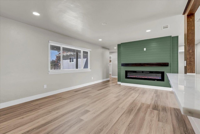 unfurnished living room with light hardwood / wood-style floors