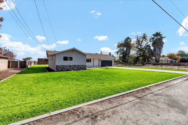 ranch-style house featuring a garage and a front lawn