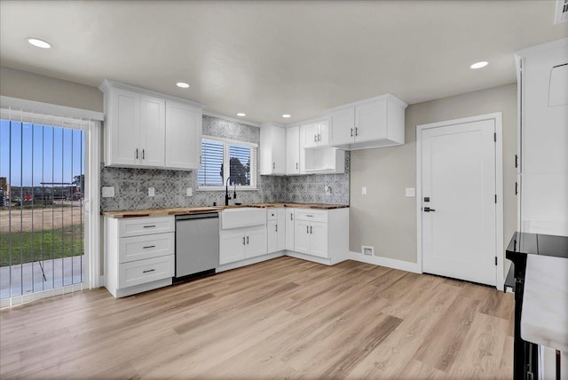 kitchen with dishwasher, light hardwood / wood-style flooring, white cabinetry, and butcher block countertops