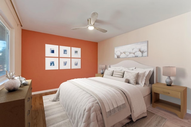 bedroom featuring ceiling fan and light hardwood / wood-style floors