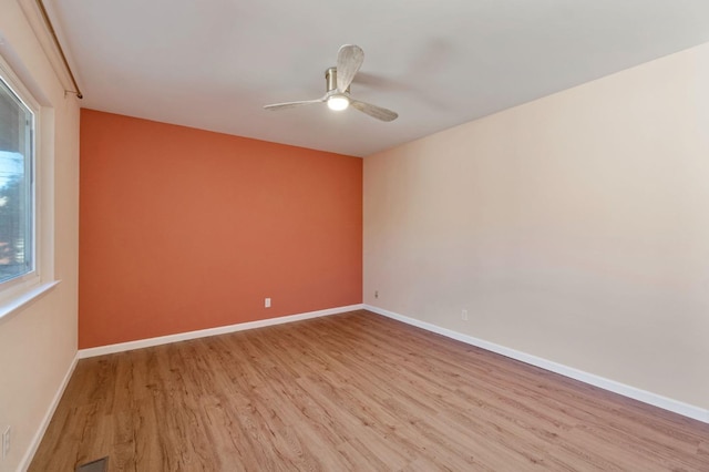 spare room featuring ceiling fan and light hardwood / wood-style flooring