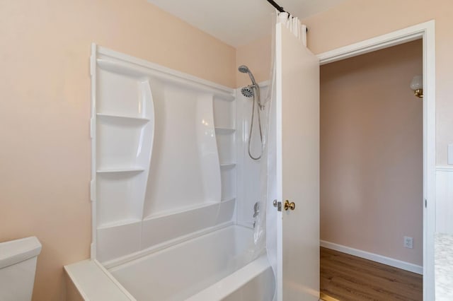 bathroom with shower / tub combination, toilet, and hardwood / wood-style flooring