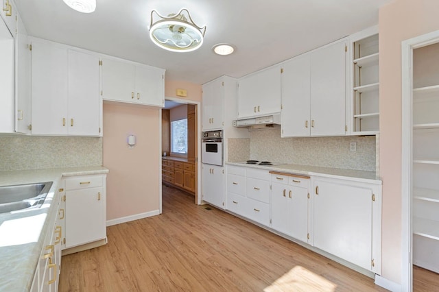 kitchen featuring backsplash, white cabinetry, white appliances, and light wood-type flooring