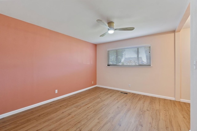 empty room featuring ceiling fan and light wood-type flooring