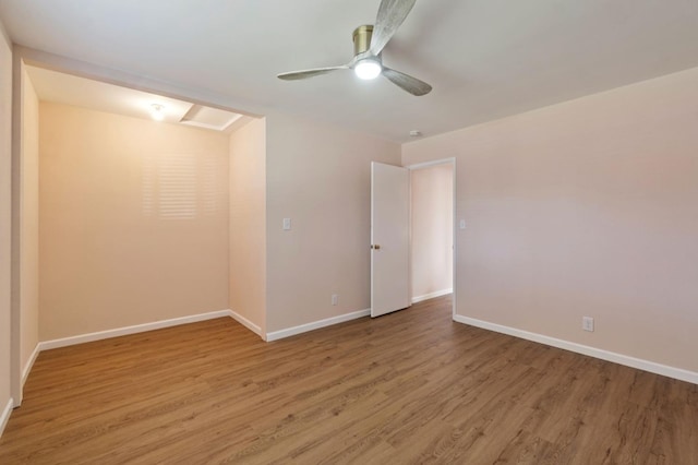 empty room featuring ceiling fan and wood-type flooring