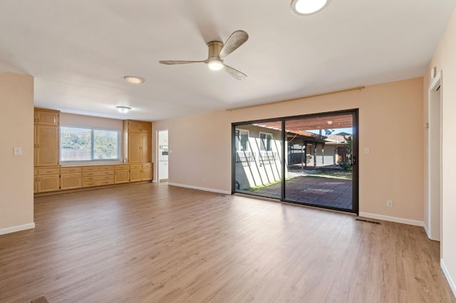 spare room featuring ceiling fan and light hardwood / wood-style flooring