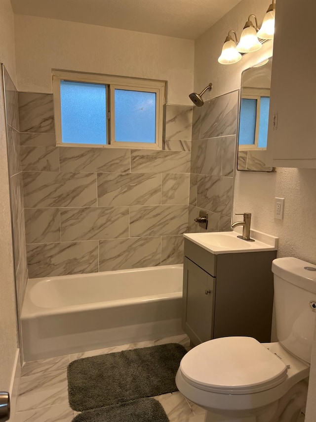 full bathroom with vanity, toilet, and tiled shower / bath