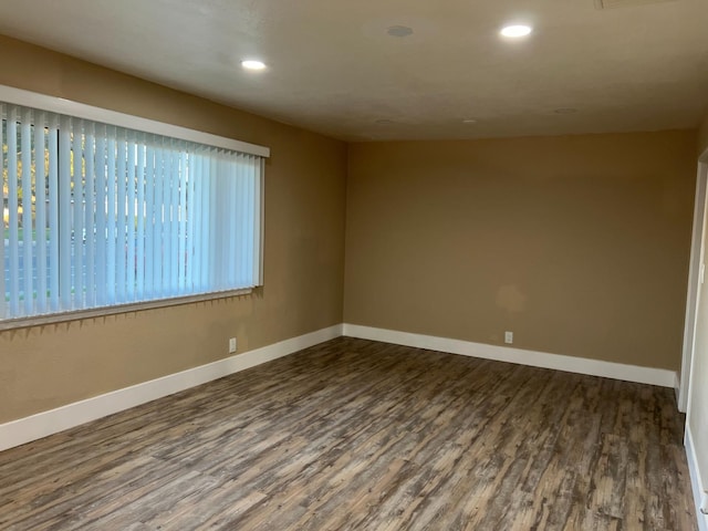 spare room featuring dark hardwood / wood-style flooring