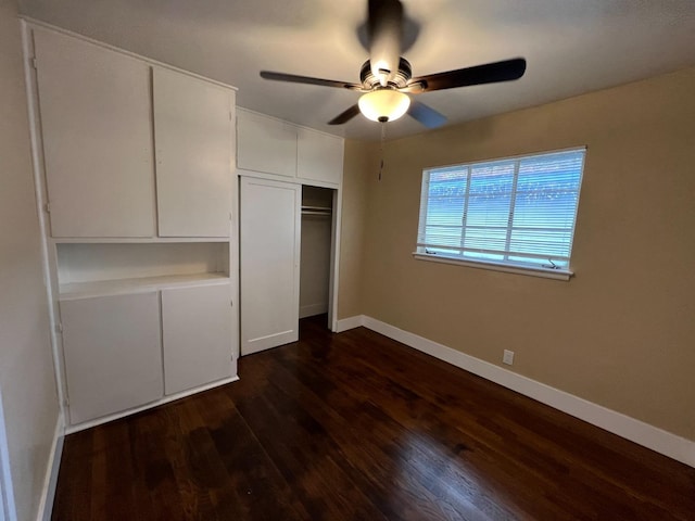 unfurnished bedroom with dark wood-type flooring, a closet, and ceiling fan