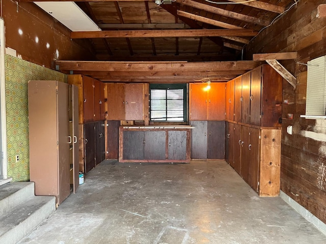 basement featuring wooden walls