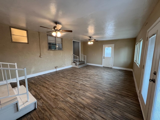 unfurnished living room with ceiling fan and dark hardwood / wood-style flooring