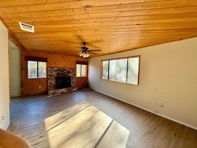 unfurnished living room with wood ceiling, hardwood / wood-style flooring, ceiling fan, lofted ceiling, and a fireplace