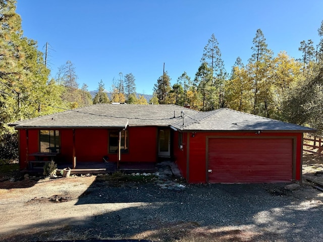 single story home featuring a garage and covered porch