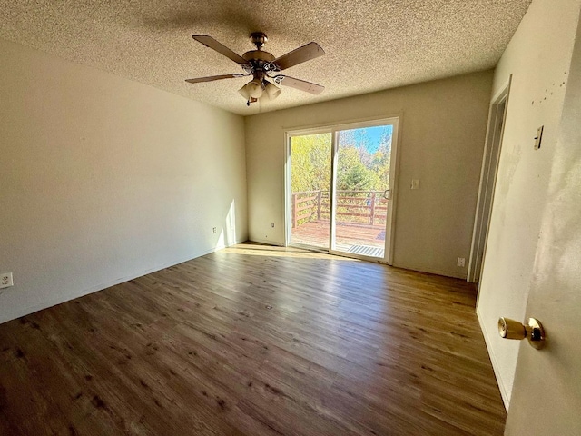 empty room featuring hardwood / wood-style flooring, a textured ceiling, and ceiling fan