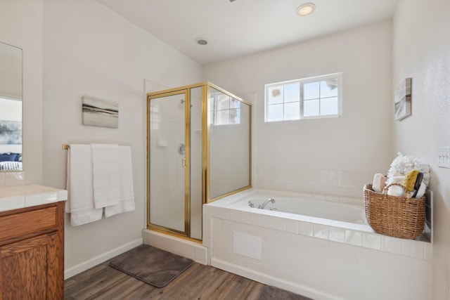 bathroom featuring hardwood / wood-style floors, vanity, and separate shower and tub