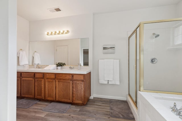 bathroom with vanity, plus walk in shower, and wood-type flooring