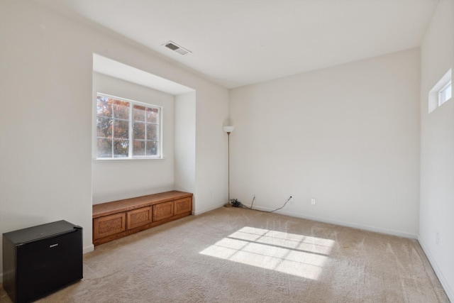 carpeted spare room featuring a healthy amount of sunlight