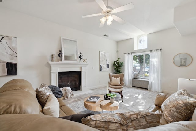 living room with ceiling fan and light wood-type flooring