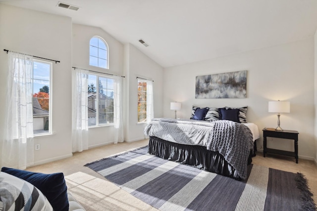 bedroom featuring light colored carpet and vaulted ceiling