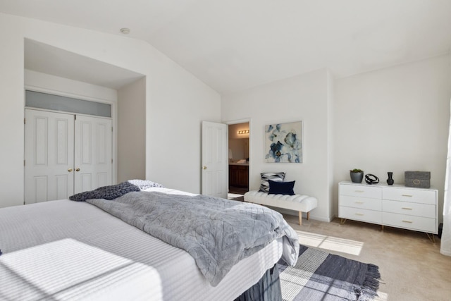 carpeted bedroom featuring lofted ceiling and a closet