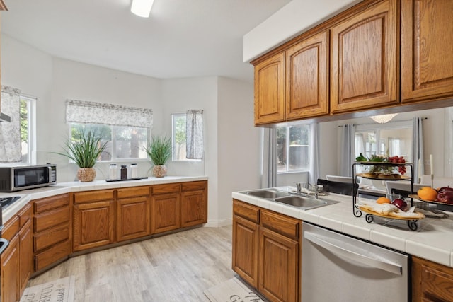 kitchen featuring plenty of natural light, light wood-type flooring, and appliances with stainless steel finishes