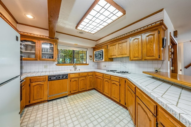 kitchen featuring tasteful backsplash, tile counters, white appliances, and ornamental molding