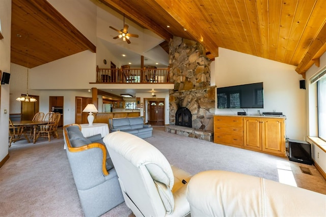 carpeted living room featuring wood ceiling, ceiling fan with notable chandelier, high vaulted ceiling, beamed ceiling, and a fireplace