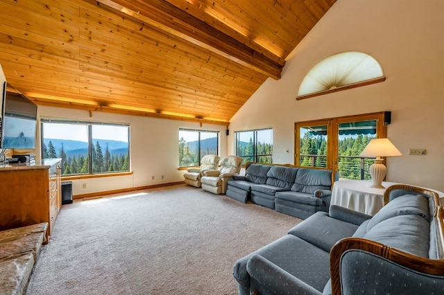 carpeted living room featuring beamed ceiling, high vaulted ceiling, a wealth of natural light, and wooden ceiling