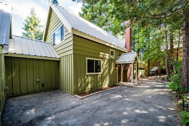 view of property exterior with a patio area