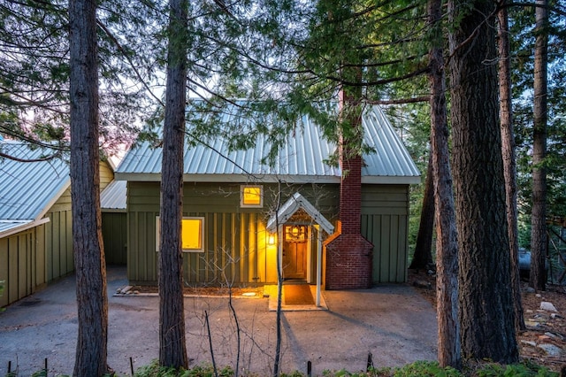 view of front of house featuring board and batten siding and metal roof