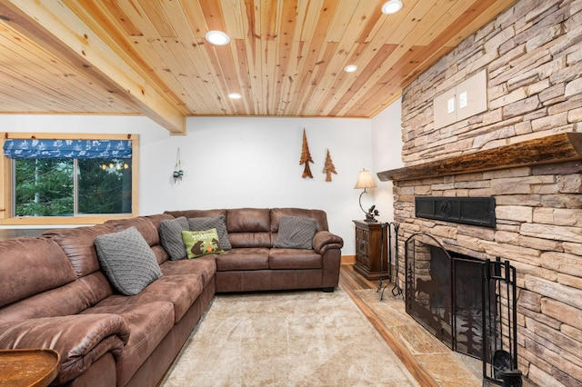 living room featuring beam ceiling, a fireplace, recessed lighting, wood finished floors, and wooden ceiling