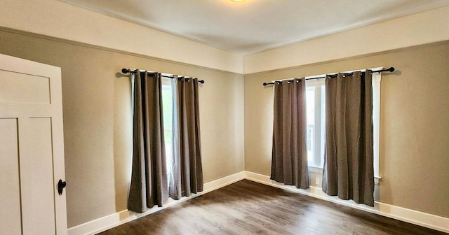 spare room with dark wood-type flooring