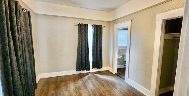 unfurnished bedroom featuring dark hardwood / wood-style floors