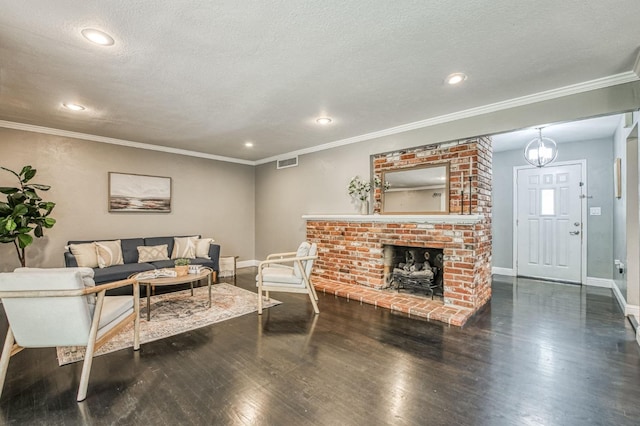 living room with a fireplace, crown molding, dark wood-type flooring, and a textured ceiling