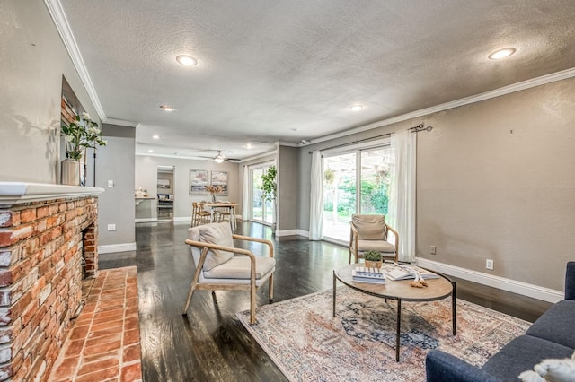 living room with crown molding, a textured ceiling, ceiling fan, a fireplace, and hardwood / wood-style floors