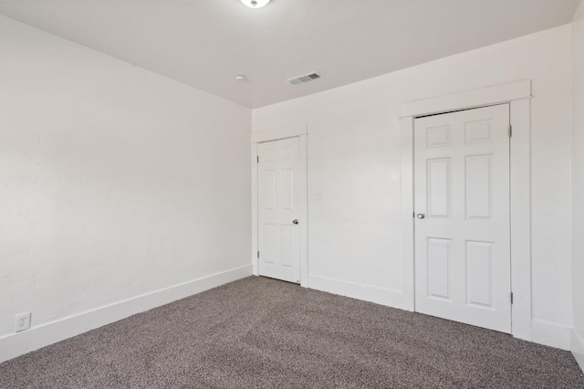 unfurnished bedroom with a closet and carpet floors