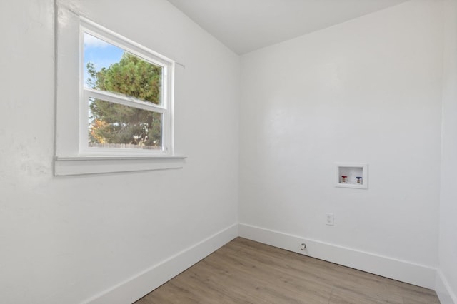 laundry area with washer hookup and light hardwood / wood-style floors