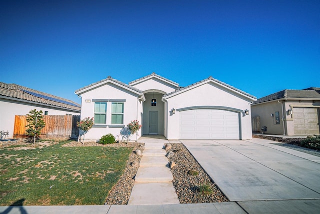 view of front of home with a front yard and a garage