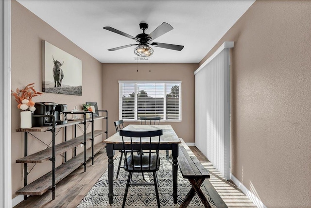 dining area featuring ceiling fan and light hardwood / wood-style floors