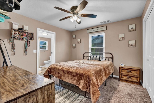 bedroom with ceiling fan, carpet floors, connected bathroom, and a closet