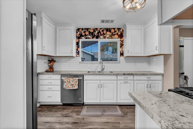 kitchen with white cabinetry, dishwasher, sink, backsplash, and hardwood / wood-style floors