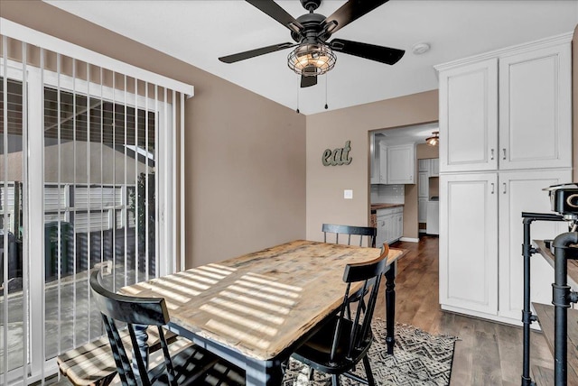 dining space featuring ceiling fan and dark hardwood / wood-style flooring