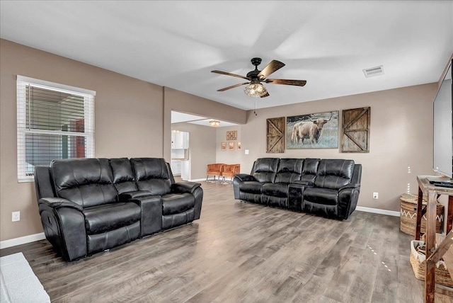 living room with hardwood / wood-style flooring and ceiling fan