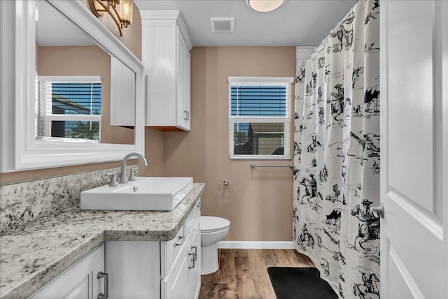 bathroom with a shower with shower curtain, vanity, toilet, and wood-type flooring