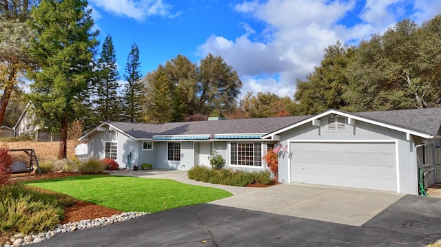 ranch-style house featuring a garage and a front yard