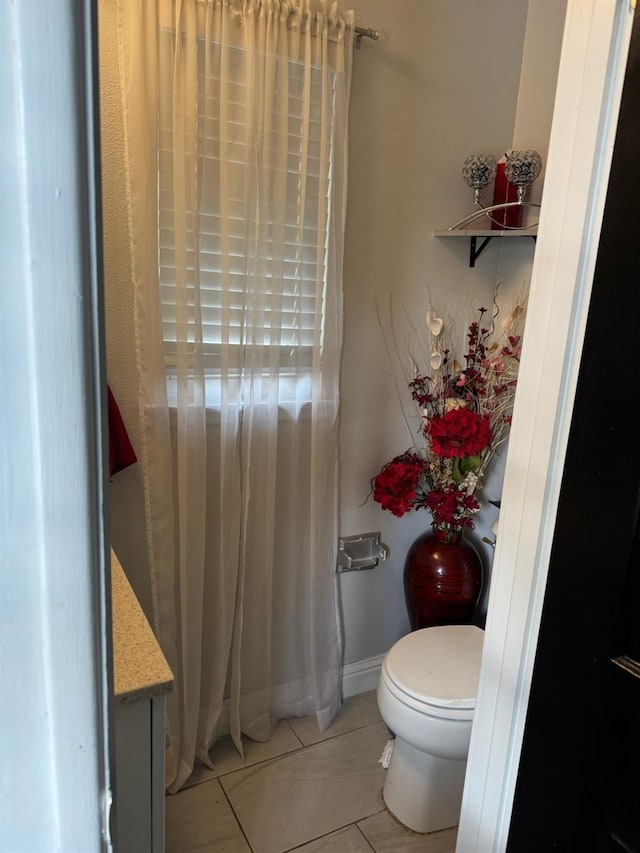 bathroom with vanity, tile patterned flooring, toilet, and baseboards