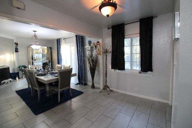 dining space featuring baseboards