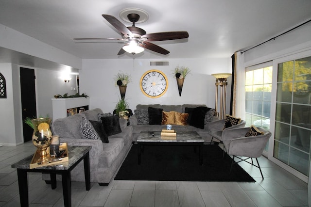 living room featuring ceiling fan and visible vents