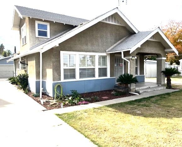 view of front of home with an outbuilding and a front lawn